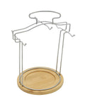 Metal stand for 12-piece porcelain coffee and tea set with wooden base.