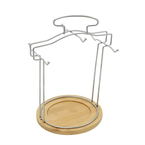 Metal stand for 12-piece porcelain coffee and tea set with wooden base.